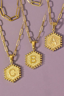  Make a statement with our stylish 2 row double sided hexagon initial pendant necklace! This unique piece features a 16" chain necklace and an 18" chain adorned with a hexagon initial pendant. The front side showcases your initial, while the back side surprises with a delicate heart design. Adjustable from 16-18" with a 3" extender, this necklace is a versatile and chic addition to any jewelry collection.